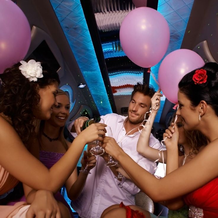 Passengers celebrating inside a limousine with balloons