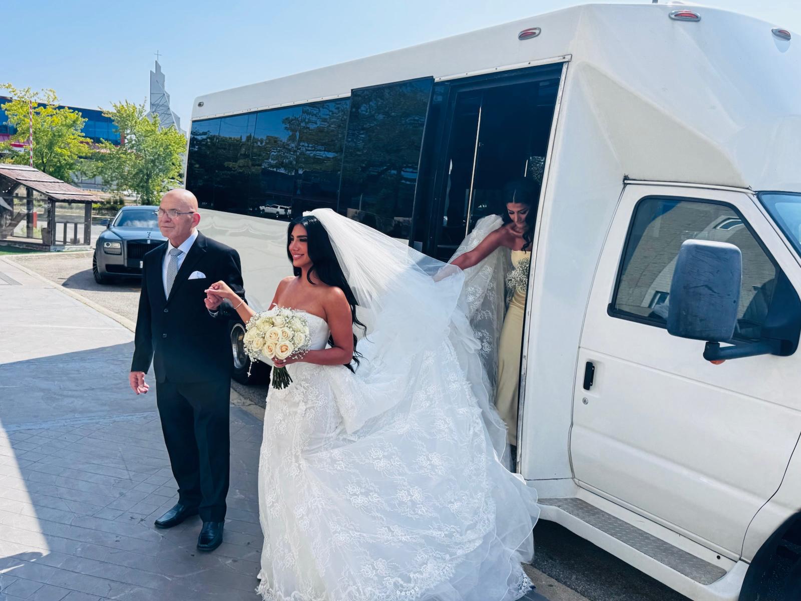 Bride and wedding party boarding a white party bus for wedding transportation in Toronto